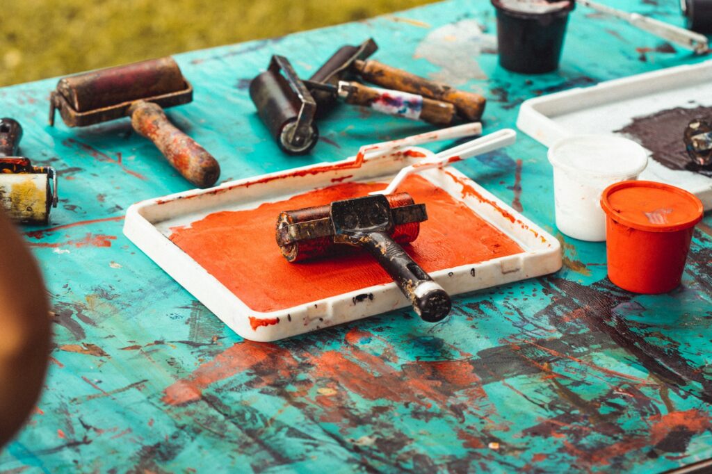 Ink rollers and trays of coloured ink on a worktable
