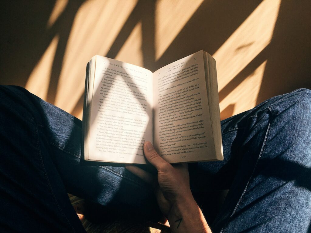 An open book held in warm late-afternoon light