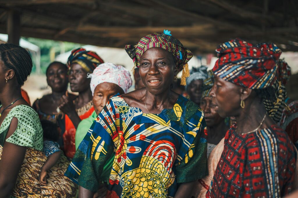 A group of women singing together in colourful dress